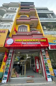 a store with a red sign in front of a building at Hanoi Backpackers Lodge in Hanoi