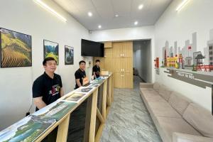 a group of men standing at a counter in a store at Hanoi Backpackers Lodge in Hanoi