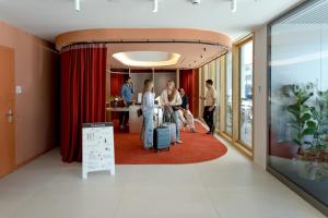 a group of people in a room with red curtains at Kora Kiliki in Pamplona +83 photos
