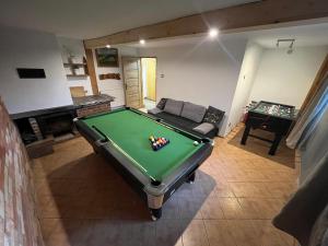 a living room with a pool table and a couch at Józka Chata max 15 os sauna jacuzzi in Porąbka