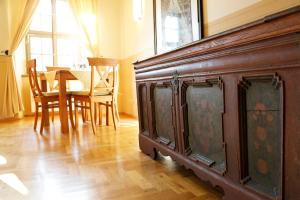a large wooden cabinet in a room with a table at Gästehaus im Flüsterbogen in Görlitz +40 photos