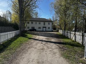 a dirt road in front of a white house at Sörbyvägen 4 in Floby