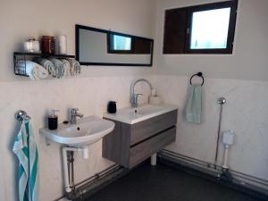 a bathroom with two sinks and a mirror at Glamping hut with panorama view in Björköby