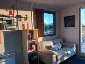 a living room with a couch and a window at Glamping hut with panorama view in Björköby