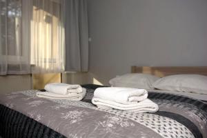 three towels are stacked on top of a bed at Nad Zalewem - pokoje przy plaży in Kobyla Góra +22 photos