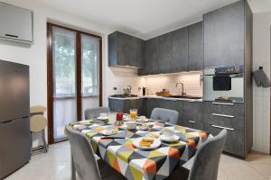 a kitchen with a table and chairs in a kitchen at Villa In Saronno in Saronno