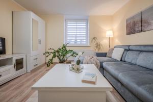 a living room with a couch and a table at Leonardo Vila Centre in Palanga