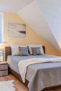 a bedroom with a large bed with two pillows at Leonardo Vila Centre in Palanga +9 photos