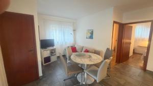 a small dining room with a table and chairs at Sepic Apartments in Opatija