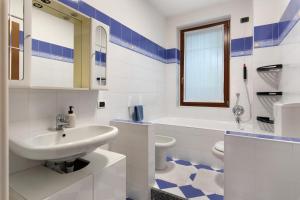 a white bathroom with a sink and a toilet at Villa In Saronno in Saronno +25 photos