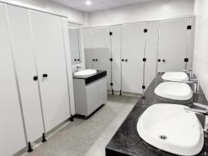 a bathroom with three sinks and four toilets at Hanoi Backpackers Lodge in Hanoi +21 photos