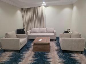 a living room with two couches and a coffee table at جلنار الشرق للشقق المخدومة in Jeddah