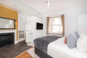 a bedroom with a bed and a fireplace at The Berkeley Square Hotel Bristol in Bristol