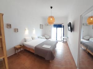 a bedroom with a bed and a room with a mirror at Lydia Mare in Agios Kirykos +24 photos