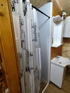 a bathroom with a sink and a shower curtain at Brvnara Nido in Cetinje +1 photo
