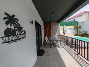 a sign on the side of a house with a swimming pool at Sunnyside cottage Bilgah in Bilgah