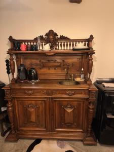 an old wooden cabinet with a sink in a kitchen at Karja Castle Apartments in Haapsalu