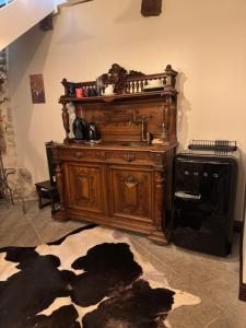 a large wooden cabinet in a room with a rug at Karja Castle Apartments in Haapsalu