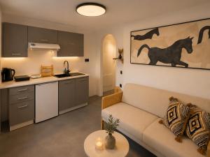 a living room with a couch and a kitchen at Ecolodge Cave House in Vóthon