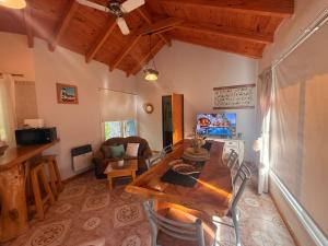 a living room with a wooden table and chairs at Flor de Lis Casas de Campo in Los Cocos
