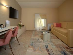 a living room with a couch and a table at Palazzo Brunamonti Boutique Hotel in Bevagna