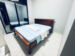a bed in a room with a large window at The Gateway Luxury Apartment in Kigali