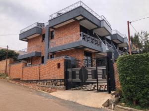 a brick building with a balcony on the side of it at The Gateway Luxury Apartment in Kigali