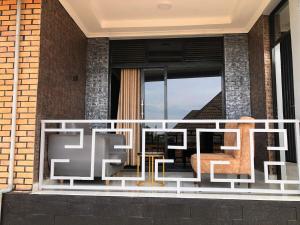 a balcony with a table and chairs on it at The Gateway Luxury Apartment in Kigali +6 photos