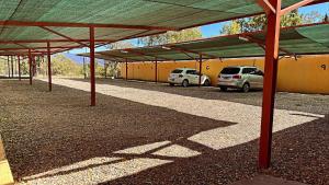 a covered parking lot with cars parked in it at Hostel Lemon Tree in Ciudad Lujan de Cuyo