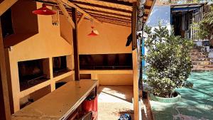 an outside view of a house with a table and a plant at Hostel Lemon Tree in Ciudad Lujan de Cuyo +5 photos