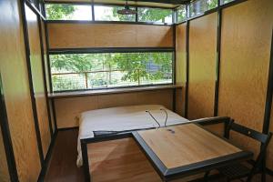 a small room with a table and a window at IRON Cabin in Gaylyunay
