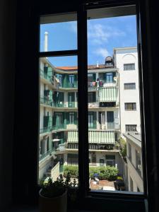 a window with a view of a building at Centro - doppia in casa d'artista in Turin +3 photos