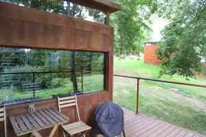 a screened in porch with a bench and a window at IRON Cabin in Gaylyunay +8 photos