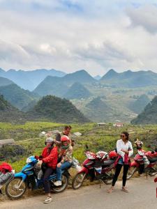 a group of people sitting on motorcycles on a mountain at Hanoi Backpackers Lodge in Hanoi