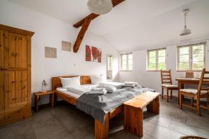 a bedroom with a bed and a table and chairs at Hotel Bolter Mühle - DZ Mohnbuchte in Rechlin
