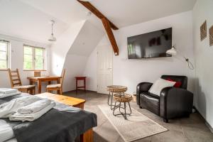 a room with a bed and a couch and a table at Hotel Bolter Mühle - DZ Mohnbuchte in Rechlin