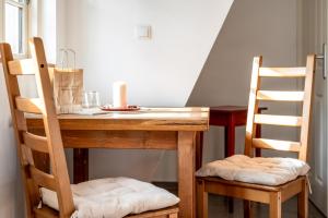 a table with two chairs and a candle on it at Hotel Bolter Mühle - DZ Mohnbuchte in Rechlin