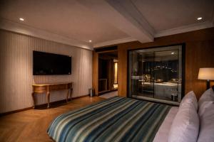 a hotel room with a bed and a television at AB's Abode-A Boutique Hotel in Mussoorie