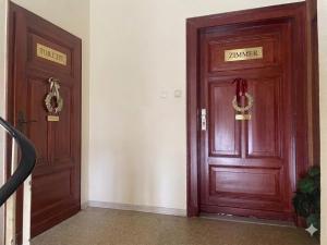 two wooden doors are next to each other at Smart in Bad Pyrmont +1 photo