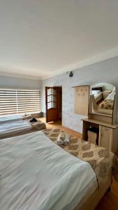 a bedroom with two large beds and a desk at Garden Sheki Hotel in Sheki +23 photos