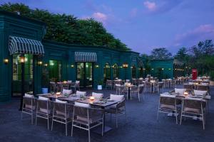 a group of tables and chairs in front of a building at JW Marriott Hotel Chandigarh in Chandīgarh