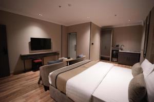 a hotel room with a large bed and a television at فندق اناف in Medina