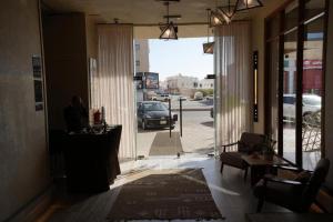 a man sitting at a desk in a room with a window at فندق اناف in Medina