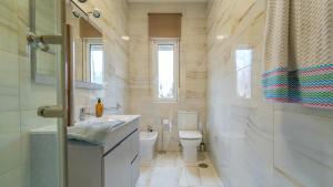 a small bathroom with a toilet and a sink at Monte la Torre in Santander +9 photos