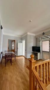 a living room with a table and a dining room at Garden Sheki Hotel in Sheki