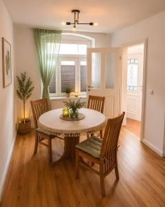 a dining room with a table and chairs at Villa Verde in Flensburg