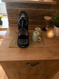 a coffee maker sitting on top of a wooden drawer at Villa Verde in Flensburg +2 photos