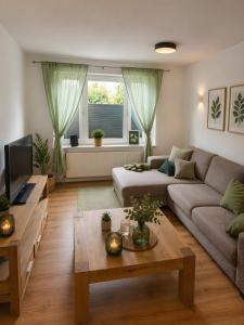 a living room with a couch and a table at Villa Verde in Flensburg