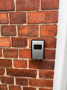 a brick wall with a tv embedded in it at Villa Verde in Flensburg