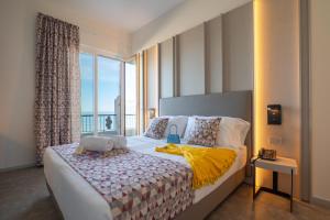 a bedroom with a bed with a large window at Hotel La Battigia in Alcamo Marina